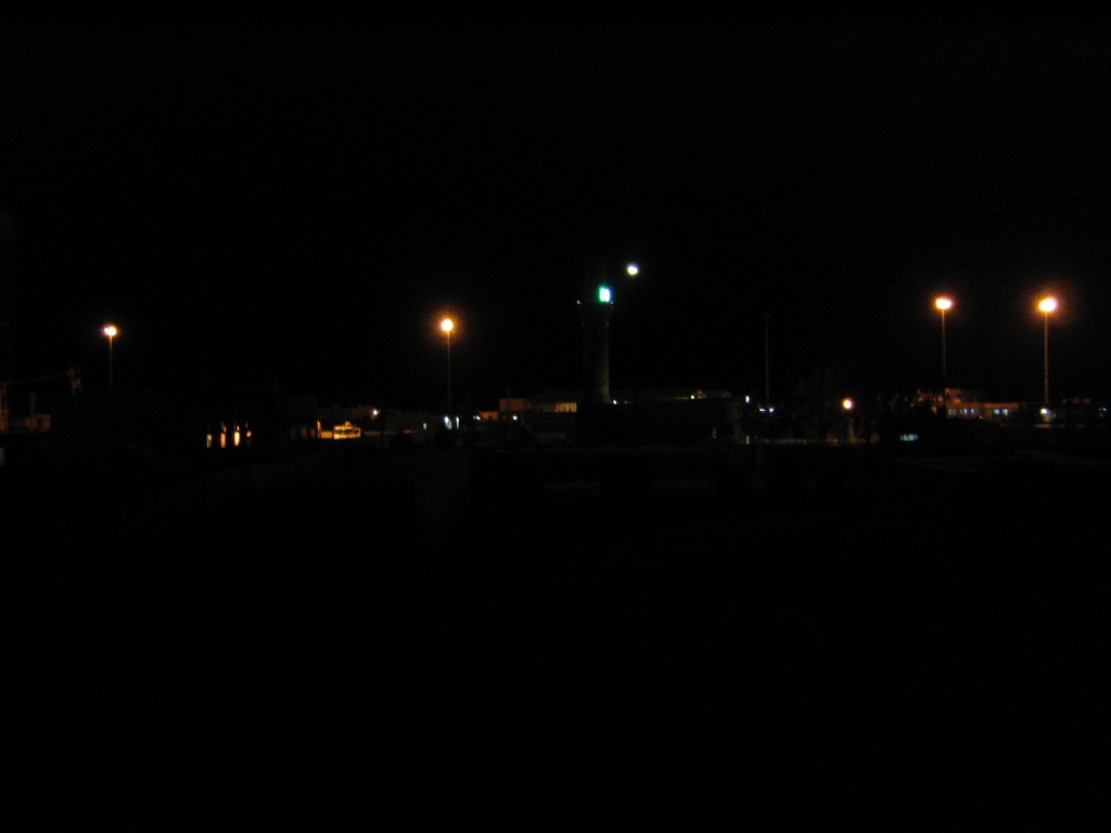 The minaret at night (at center), marked by the green and blue lights.