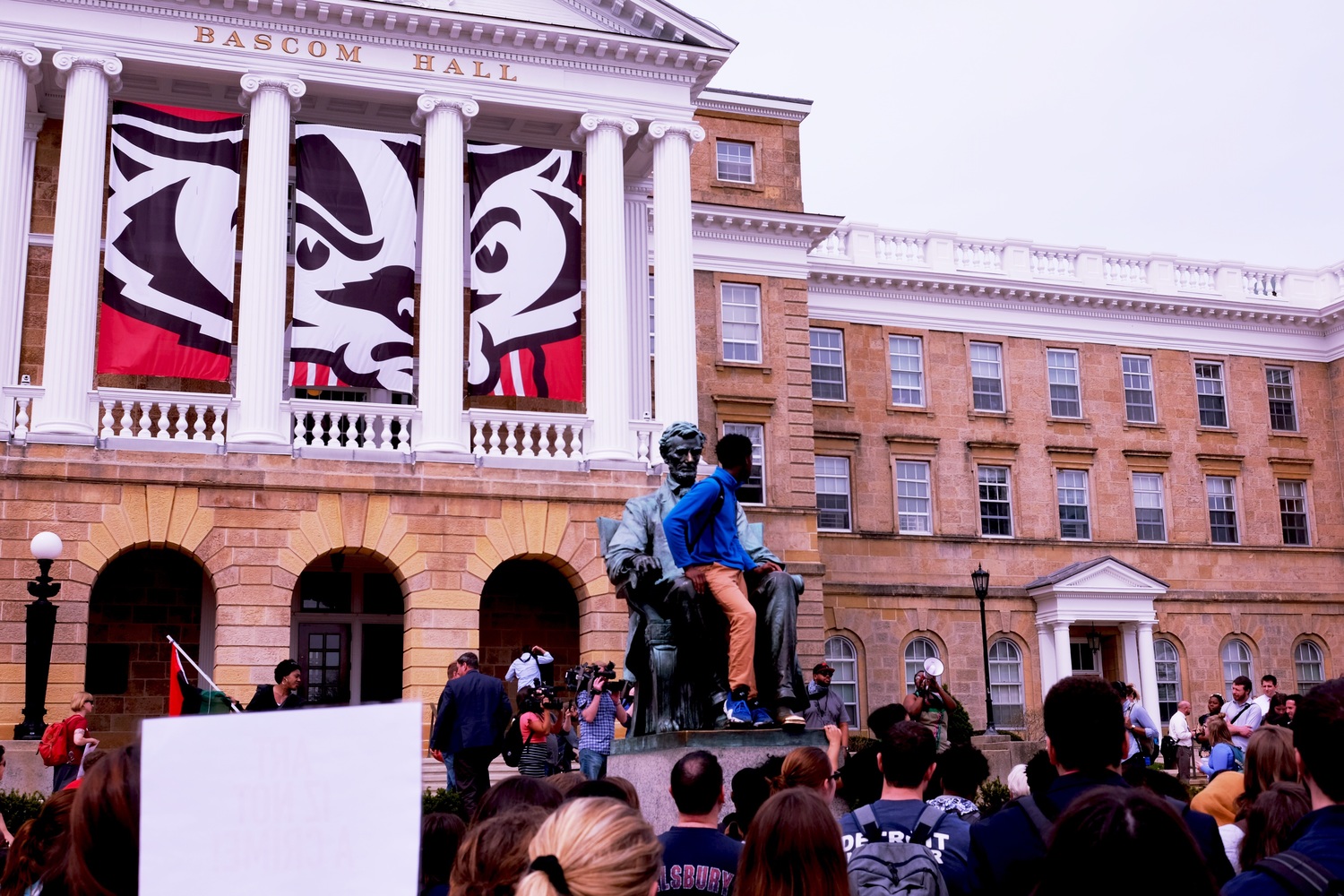 Students gathered at the Abe Lincoln statue on Bascom Mall listen to one of the organizers of the demonstration.